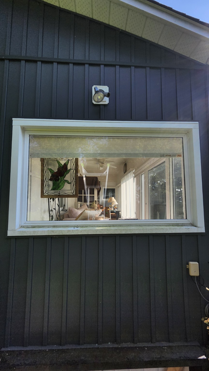 Before window cleaning: buildup visible on the white window frame and sill